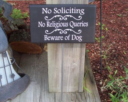 No Soliciting No Religious Queries Beware Of Dogs Sign on a Stake