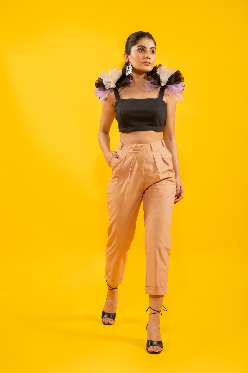 Black Ruffled Shoulder Drama Top With Tan Trousers