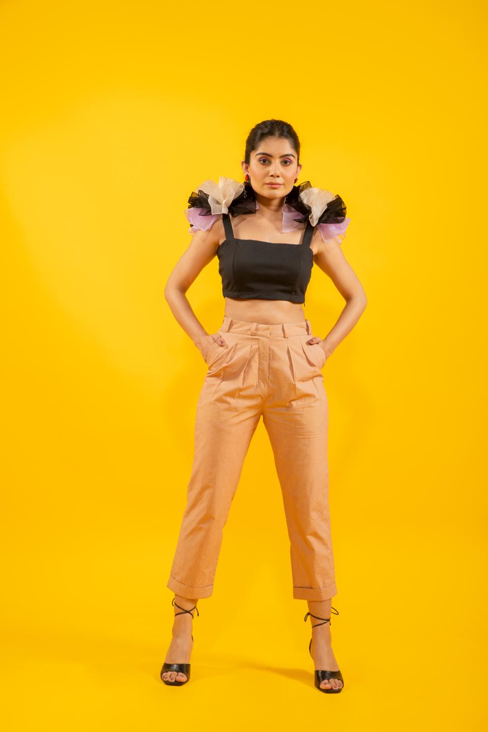 Black Ruffled Shoulder Drama Top With Tan Trousers