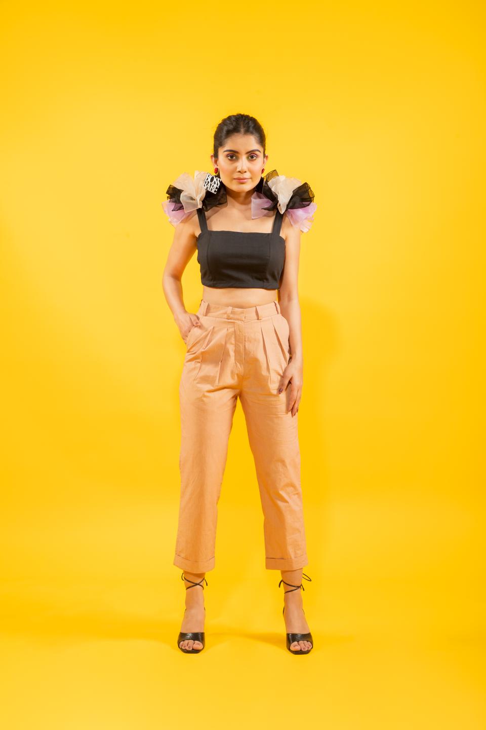 Black Ruffled Shoulder Drama Top With Tan Trousers