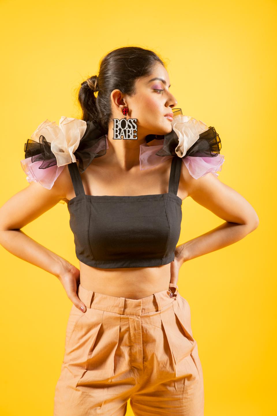 Black Ruffled Shoulder Drama Top With Tan Trousers