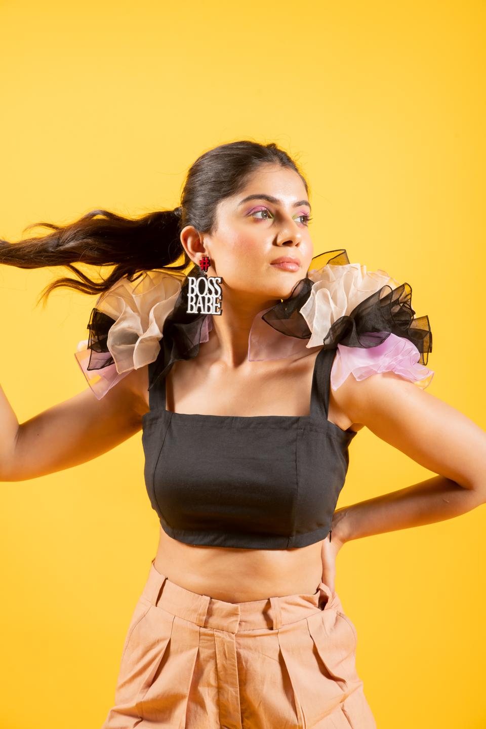 Black Ruffled Shoulder Drama Top With Tan Trousers